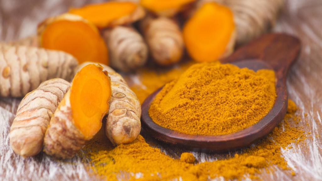 Stock image of turmeric powder and root.