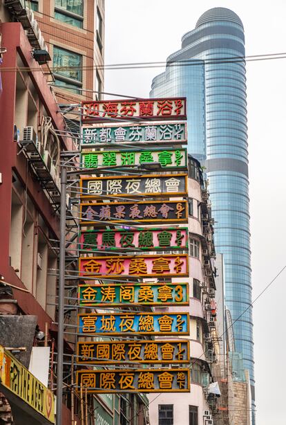 A series of neon lights that advertise various businesses in the city.