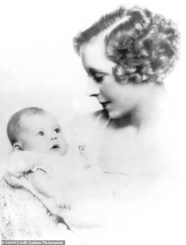 Rain is held by her mother Barbara Cartland as a baby