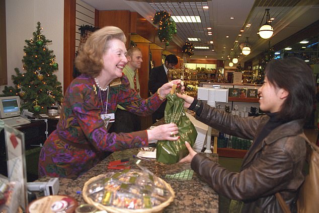 Countess Raine Spencer serves a customer in a Harrods store at Heathrow Airport in 1997